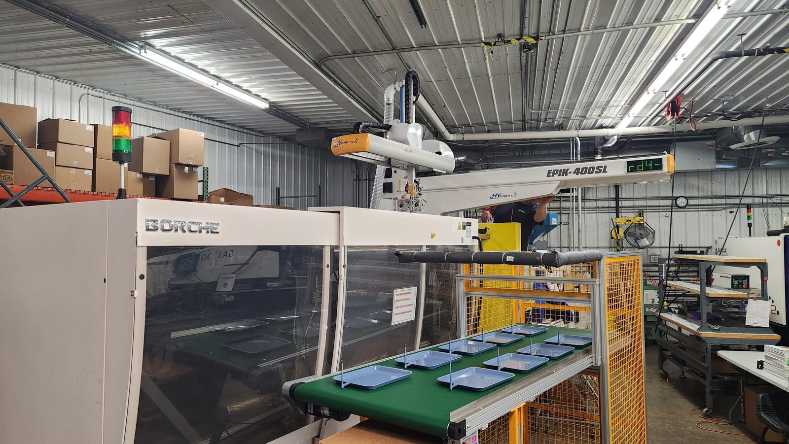 Injection moulding machine with robot handling arm (representative stock image)